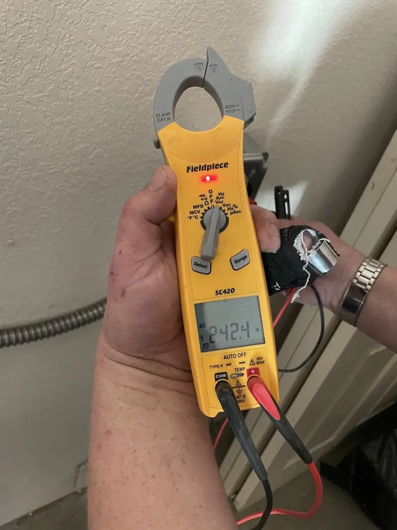Voltage testing with clamp meter during Whole House Surge Protector in Machesney Park